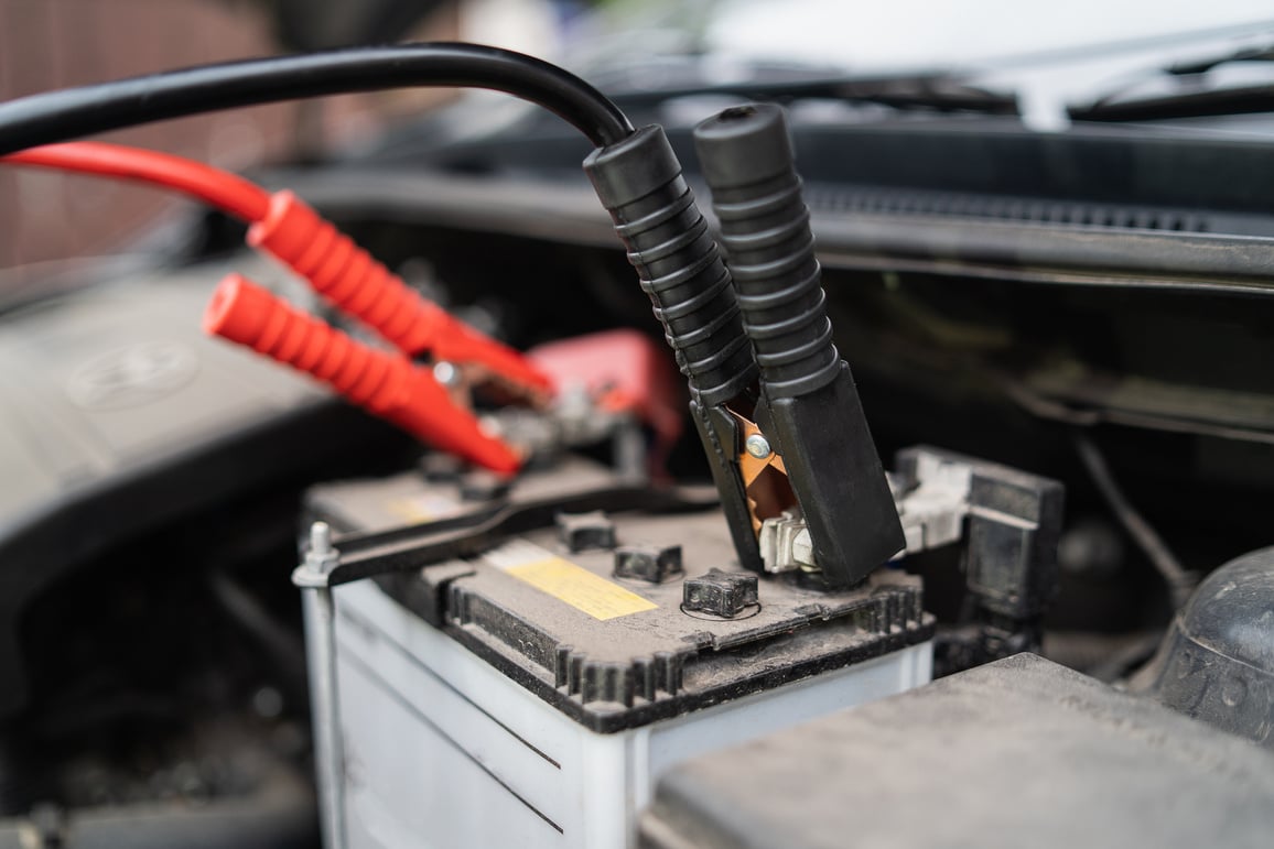 Car battery jump cable for car battery is dead. car battery charger The car battery is exhausted. Car service jumper battery transportation concept.